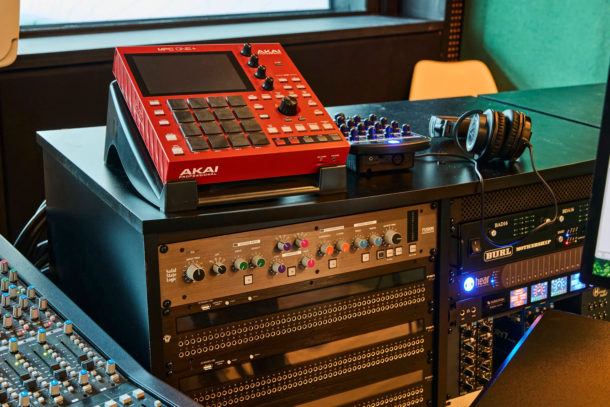 Outboard gear rack at Verdant Sound — Akai MPC One+, patch bays, and studio headphones